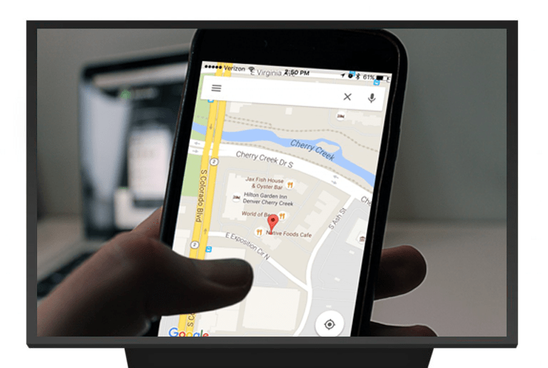 close-up image of someone holding a phone while using the google maps app