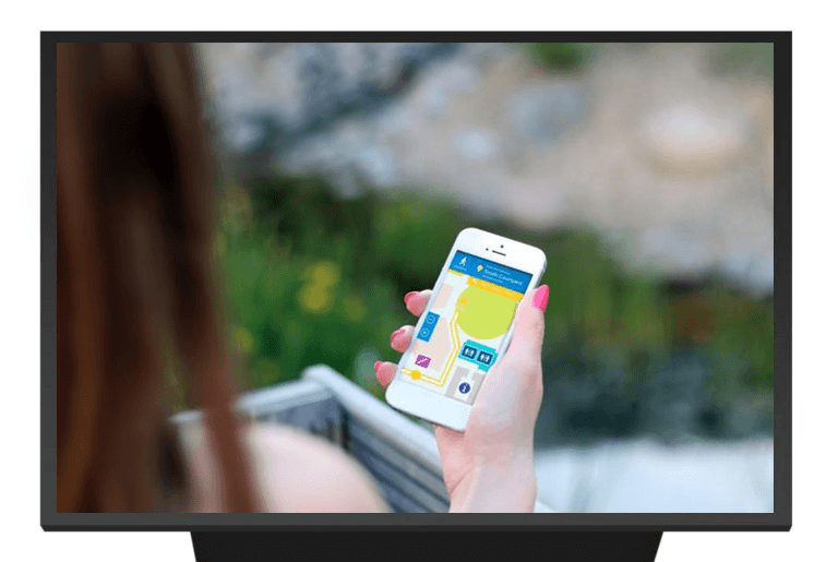woman holding a phone while using a digital signage wayfinding app